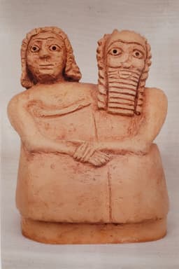 Two people sitting of the covernant Akkadian